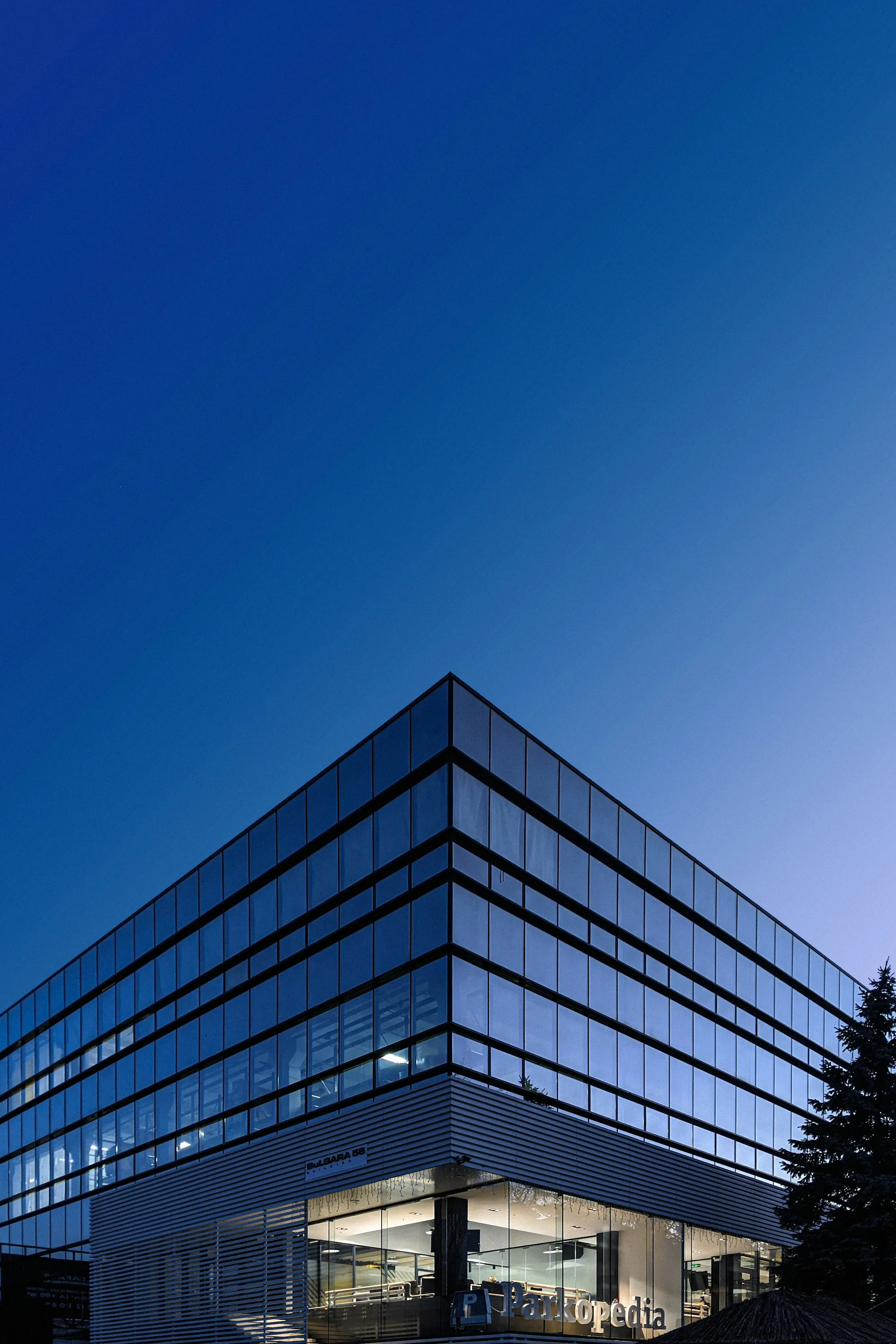 Corner of a blue glass office building